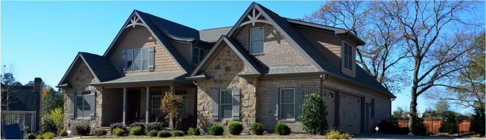 A two-story brick house with a dark gray roof.